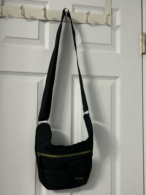 Roots Black Crossbody Bag with Green Zipper Accent